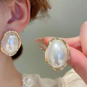 White pearl earrings.